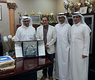 العازمي يقدم درعا تذكاريا الى د. أيمن